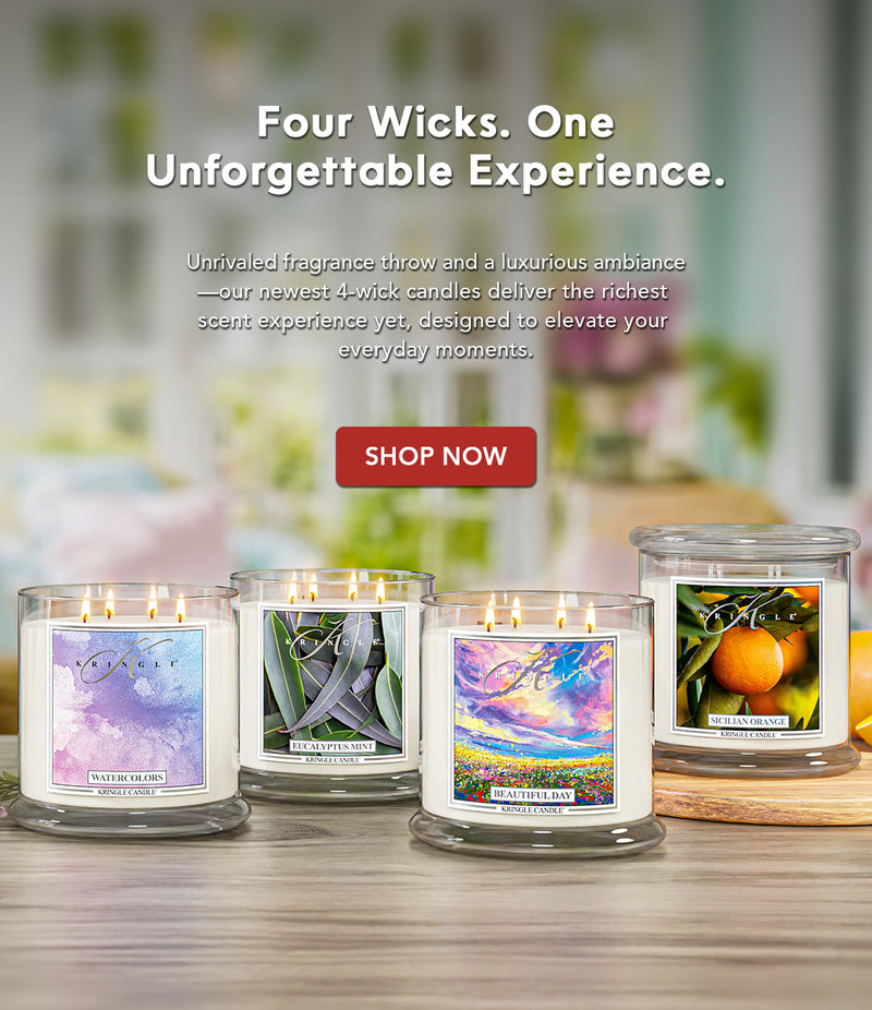 Four wick candles on a wooden surface with a blurred background