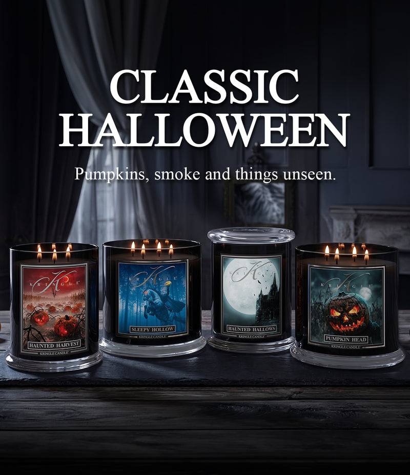 Four lit candles in black glass jars with Halloween-themed labels are displayed on a dark wooden surface under the text 'CLASSIC HALLOWEEN' and 'Pumpkins, smoke and things unseen.'.