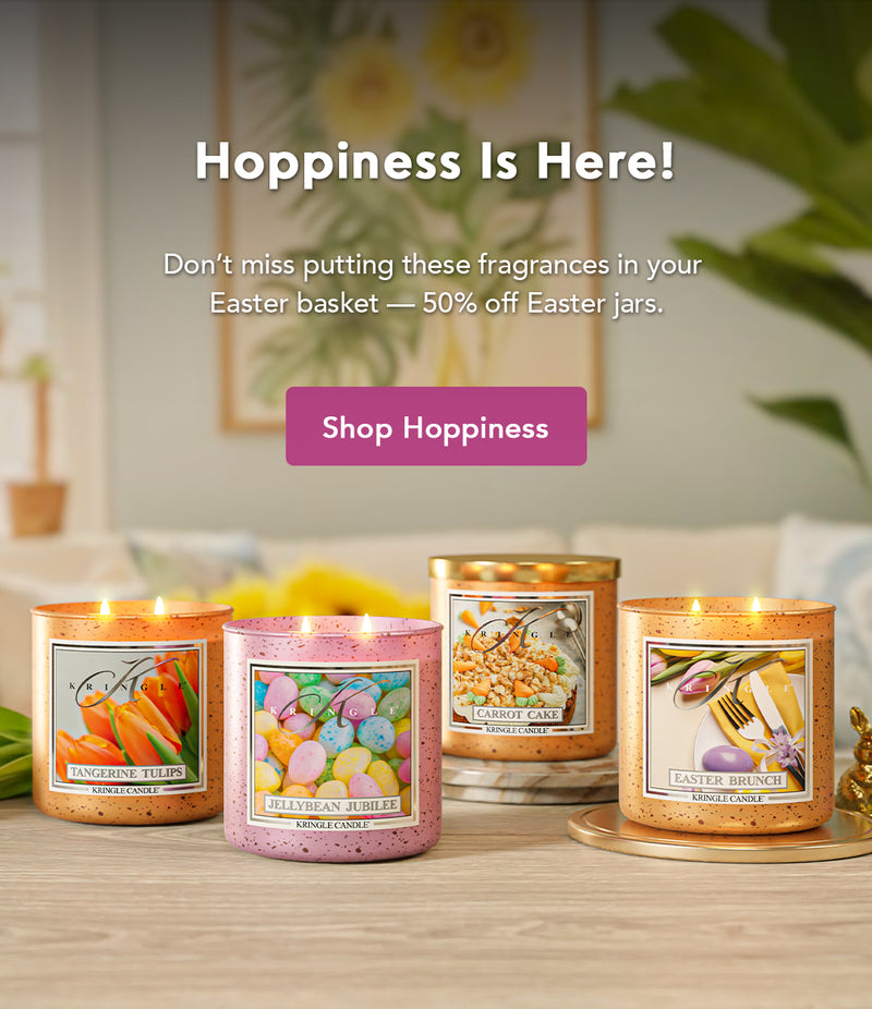Four candles with Easter-themed labels on a wooden surface, with promotional text above.