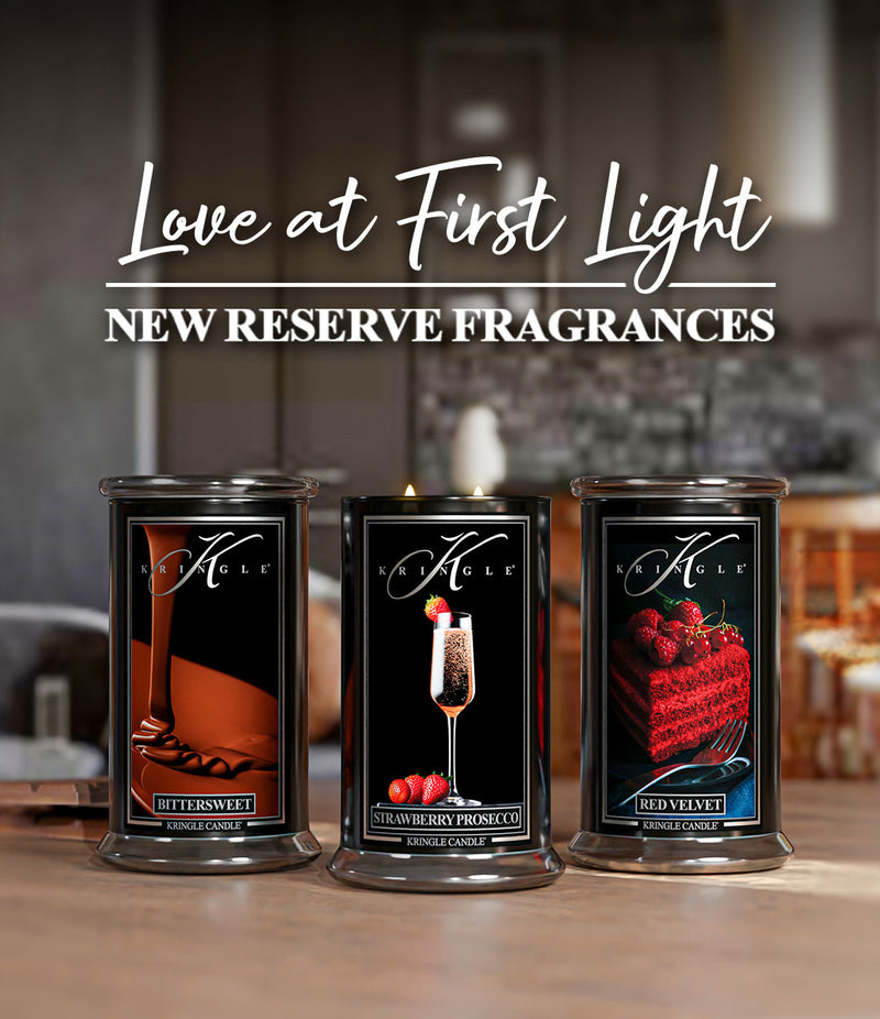 Love at First Light text and three new Kringle Candle's Reserve Collection candles, Bittersweet, Strawberry Prosecco and Red Velvet Cake candles in large jars painted black. 