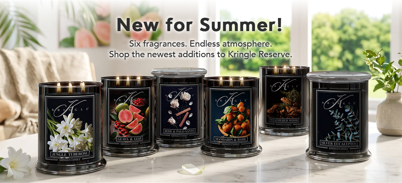 Kingle Reserve candles with various scents on a marble surface, featuring text about new summer fragrances.