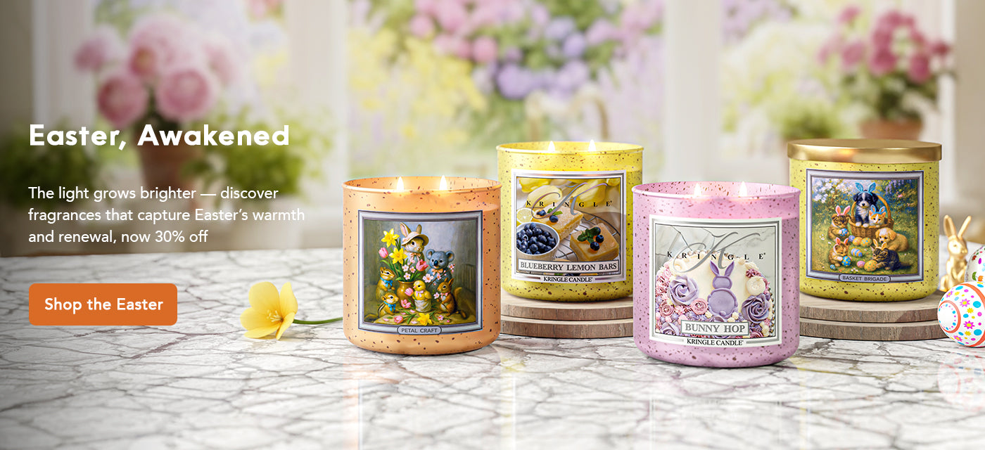 Three Easter-themed candles on a marble surface with decorative elements.