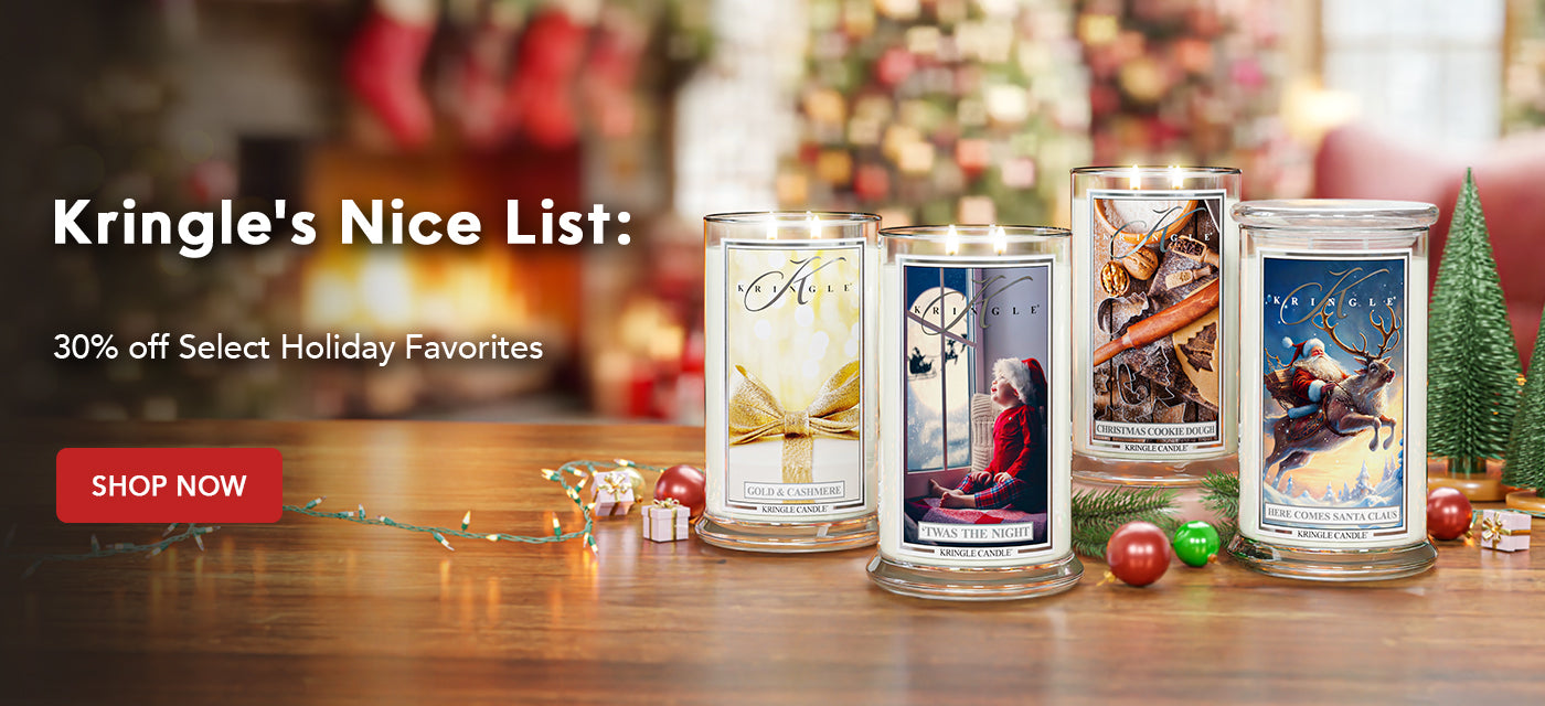 Kringle's Nice List holiday candles on a wooden table with festive background
