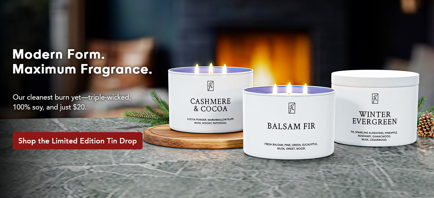 Three candles with labels on a surface in front of a fireplace, with promotional text overlay.