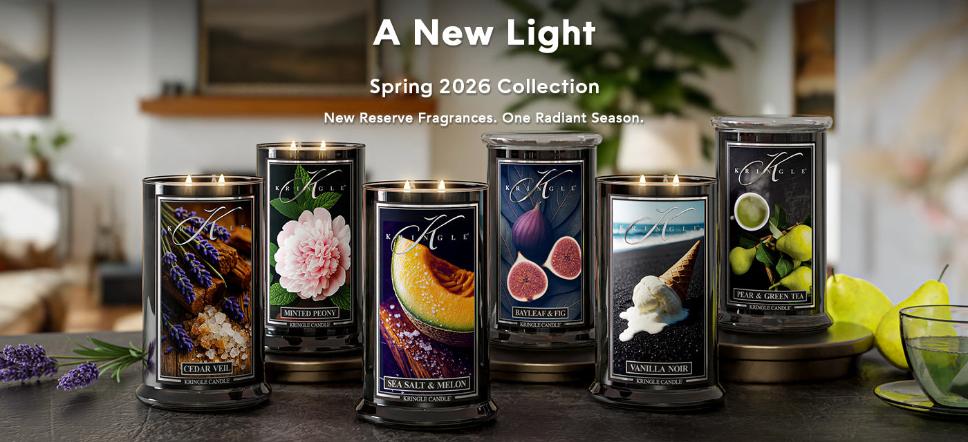 Collection of candles with decorative labels on a table, featuring 'A New Light' Spring 2026 Collection.