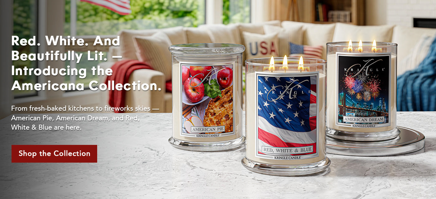 Three candles from the Americana Collection on a table with a living room background.