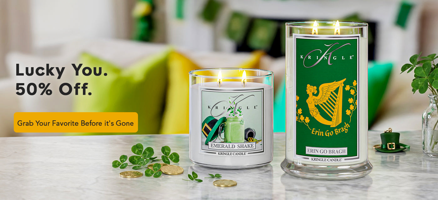 Two candles on a table with promotional text for a sale.