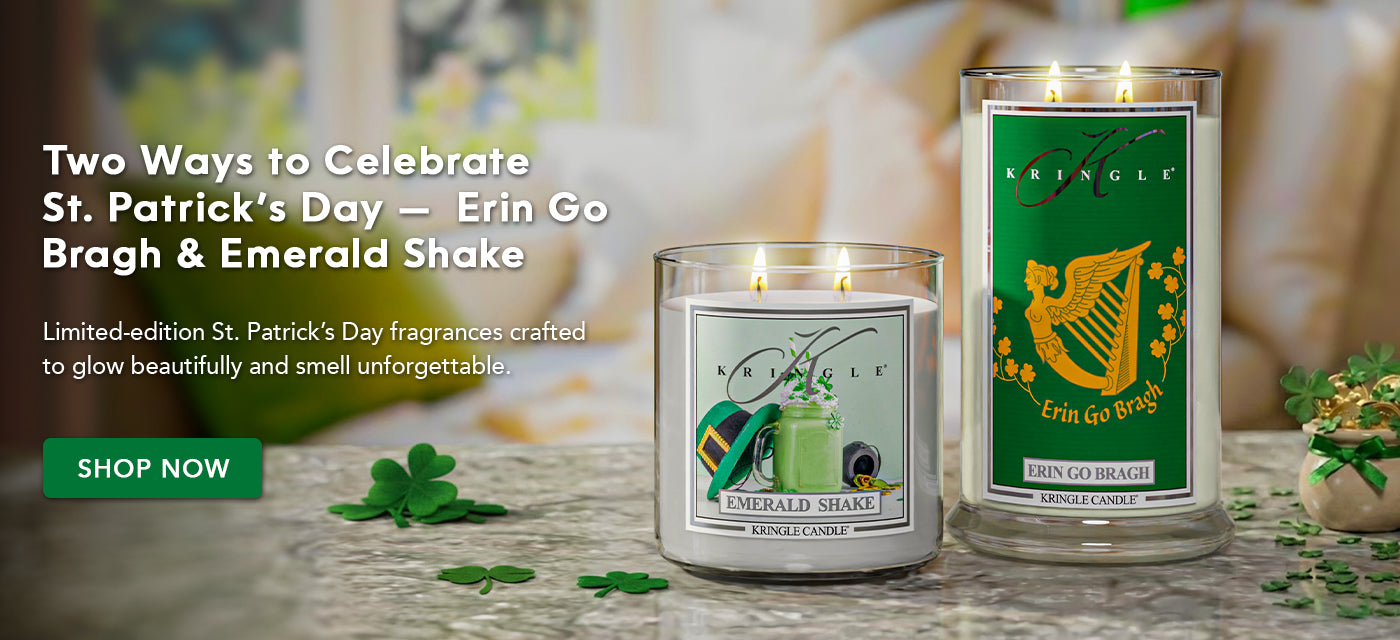 Two Kringle Candle St. Patrick's Day candles on a table with decorative elements.