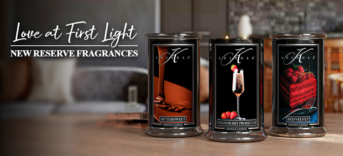 Love at First Light text and three new Kringle Candle's Reserve Collection candles, Bittersweet, Strawberry Prosecco and Red Velvet Cake candles in large jars painted black. 