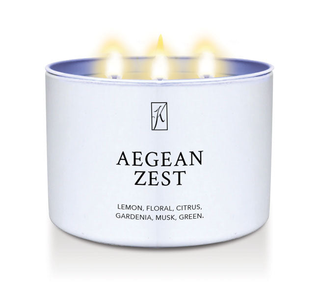 Candle in a white tin container labeled 'Aegean Zest' with a logo on a white background