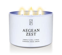 Candle in a white tin container labeled 'Aegean Zest' with a logo on a white background