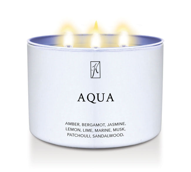 Candle in a white tin container labeled 'Aqua' with flames on a white background