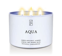 Candle in a white tin container labeled 'Aqua' with flames on a white background