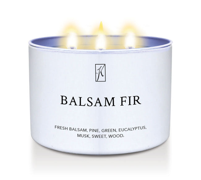 Candle in a white container labeled 'Balsam Fir' with flames on a white background