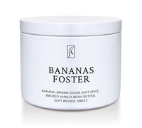 Jar of 'Bananas Foster' candle with branding on a white background