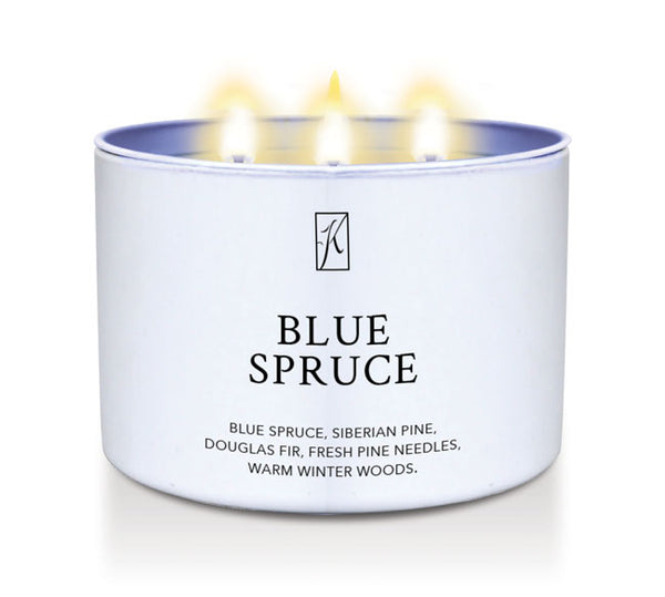 Candle in a white container labeled 'Blue Spruce' with flames on a white background