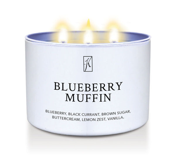 Candle in a white container labeled 'Blueberry Muffin' with a logo on a white background