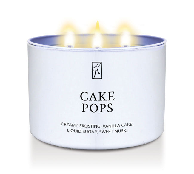 Candle in a white container labeled 'Cake Pops' with flames on a white background.