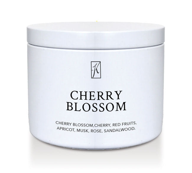 White tin container with 'Cherry Blossom' fragrance description on a white background