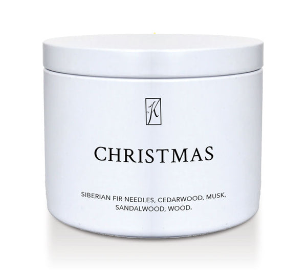White candle jar labeled 'Christmas' with fragrance description on a white background