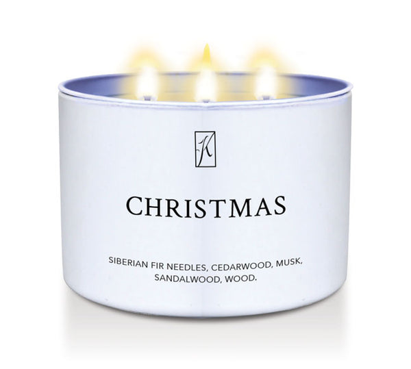 Candle in a white container labeled 'Christmas' with a logo on a white background