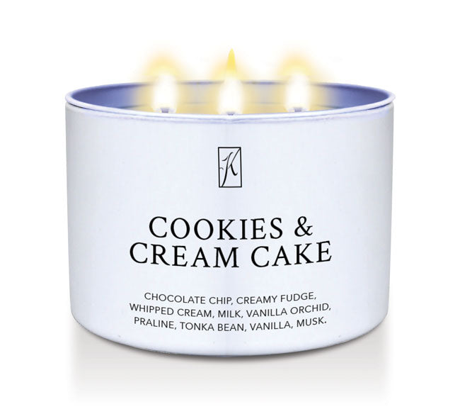 Candle in a white tin container labeled 'Cookies & Cream Cake' with flames on a white background by Kringle Candle.