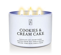 Candle in a white tin container labeled 'Cookies & Cream Cake' with flames on a white background by Kringle Candle.
