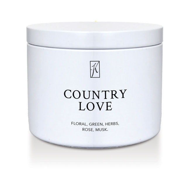 White tin container with 'Country Love' fragrance description on a white background