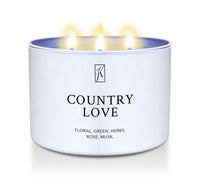 Candle in a white tin container labeled 'Country Love' with 3 wick flames on a white background