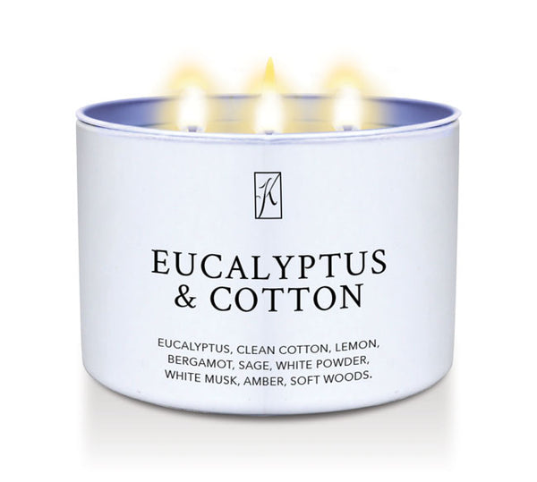 Candle in a white container labeled 'Eucalyptus & Cotton' on a white background