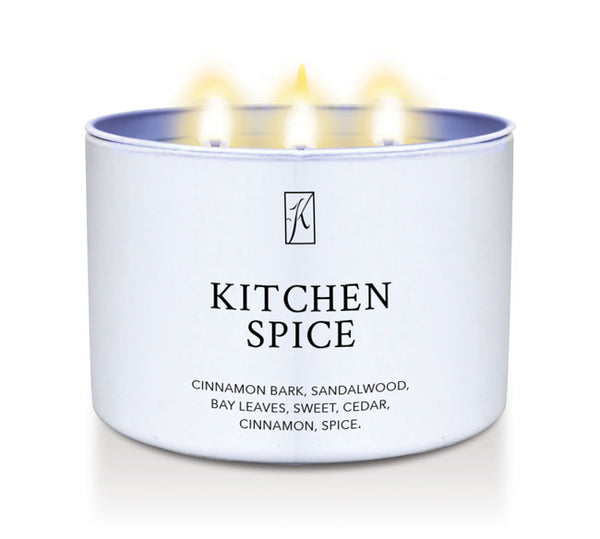 Candle in a white container labeled 'Kitchen Spice' with flames on a white background