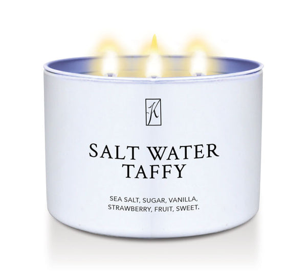 Kringle Candle Salt water taffy candle tin with a white lid on a white background