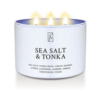 'Sea Salt & Tonka' scented candle in a tin container with 3 wicks with flames on a white background by Kringle Candle