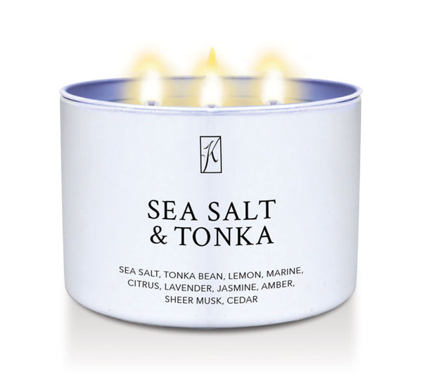 'Sea Salt & Tonka' scented candle in a tin container with 3 wicks with flames on a white background by Kringle Candle
