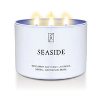 White tin candle container labeled 'Seaside' with a brand logo on a white background