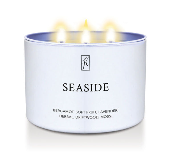White tin candle container labeled 'Seaside' with a brand logo on a white background