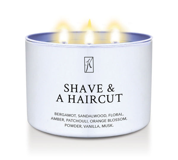 Candle in a white container labeled 'Shave & A Haircut' with flames on a white background