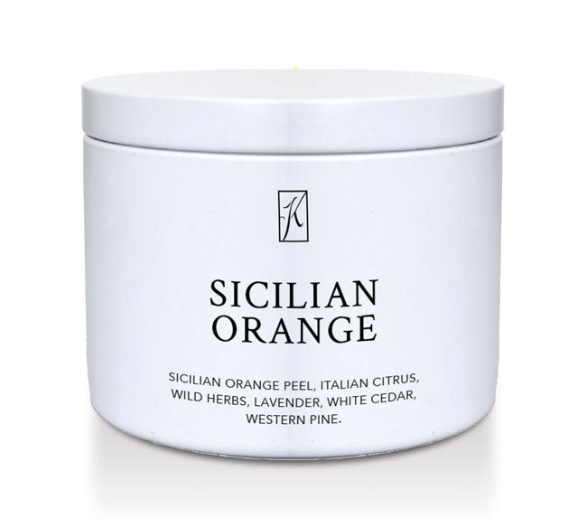 White tin candle container with 'Sicilian Orange' fragrance description on a white background
