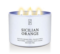 Candle in a white tin container labeled 'Sicilian Orange' on a white background