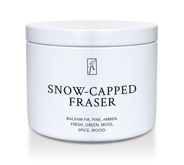 White tin container of 'Snow-Capped Fraser' candle with a logo on a white background