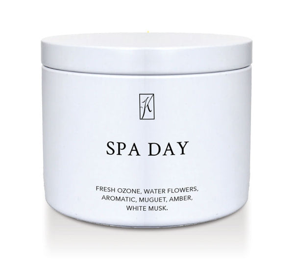 Candle in a white container labeled 'SPA DAY' with a logo on a white background