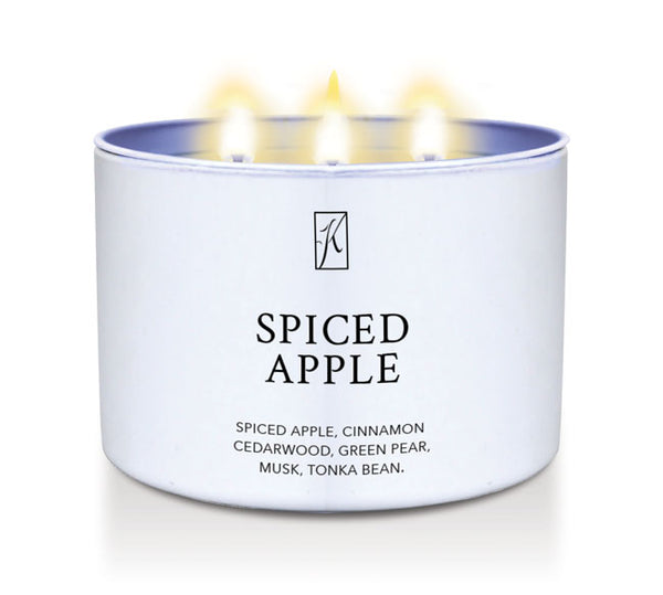 Candle in a white container labeled 'Spiced Apple' with flames on a white background