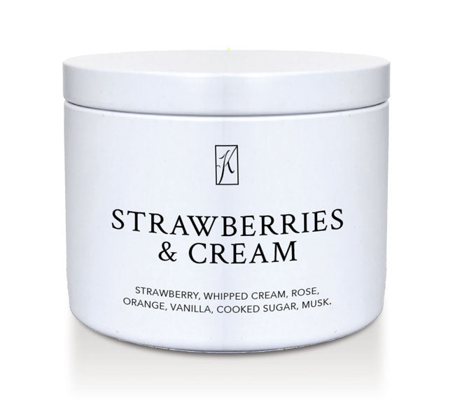 'Strawberries & Cream' scented candle in a white tin container on a white background.