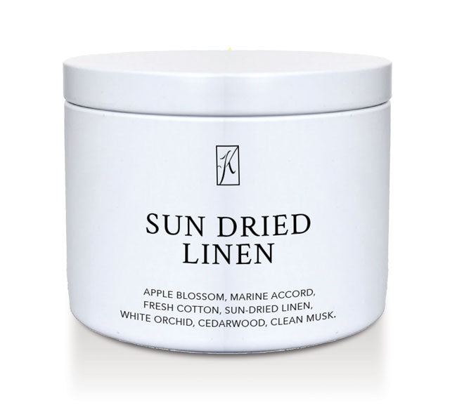 'Sun Dried Linen' fragrance candle in a white tin container on a white background