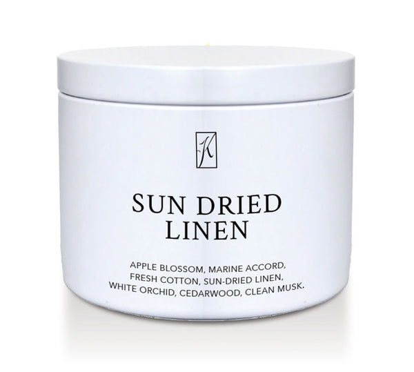 'Sun Dried Linen' fragrance candle in a white tin container on a white background
