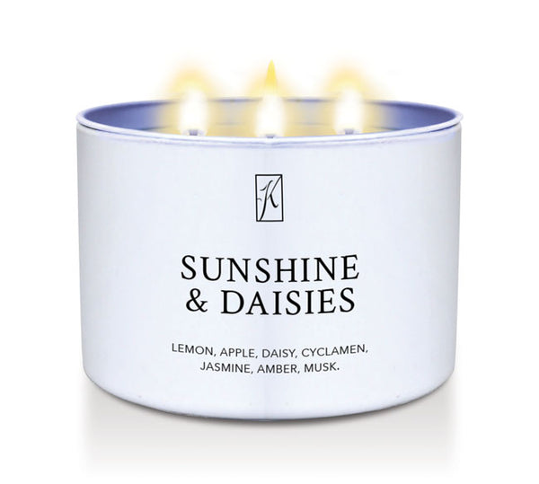 Candle in a white tin container labeled 'Sunshine & Daisies' with flames on a white background