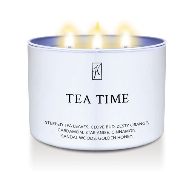 Candle in a tin container labeled 'Tea Time' with a logo on a white background.