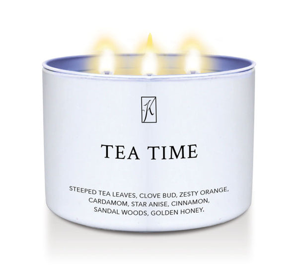 Candle in a tin container labeled 'Tea Time' with a logo on a white background.