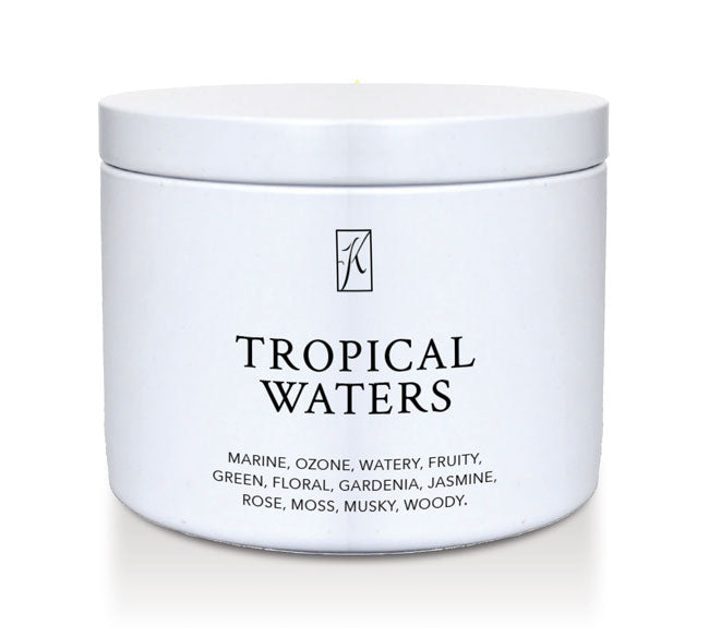 'Tropical Waters' scented candle in a tin container on a white background.