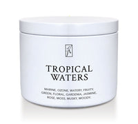 'Tropical Waters' scented candle in a tin container on a white background.